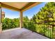 Relaxing outdoor balcony view, with iron railing overlooking lush green trees and clear blue skies at 5234 E Carol Ave, Mesa, AZ 85206
