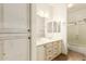 Spacious bathroom boasts a double vanity, tile floor, and a combined shower-tub with abundant light at 5234 E Carol Ave, Mesa, AZ 85206