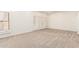 Bright bedroom with neutral carpet, shuttered window, and baseboard trim at 5234 E Carol Ave, Mesa, AZ 85206