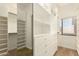 A walk-in closet with custom shelves, drawers, and a full-length mirror for convenience at 5234 E Carol Ave, Mesa, AZ 85206