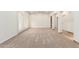 Spacious living room with neutral carpet, arched doorways, and recessed lighting at 5234 E Carol Ave, Mesa, AZ 85206