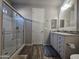 Bathroom featuring a modern vanity, glass shower, and closet, all complemented by stylish flooring at 650 N Hawes Rd # 3312, Mesa, AZ 85207