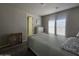 Cozy bedroom showcasing a bed with blue accents, wood furniture, and ample natural light from a window at 650 N Hawes Rd # 3312, Mesa, AZ 85207