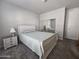 Cozy bedroom with light-colored furniture, soft carpet, and a mirrored closet door at 650 N Hawes Rd # 3312, Mesa, AZ 85207