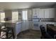 Well-lit kitchen with modern white cabinets, stainless steel appliances, and a bar seating area at 650 N Hawes Rd # 3312, Mesa, AZ 85207