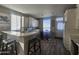 Open concept kitchen featuring white cabinetry, modern appliances, an eat-in table, and wood floors at 650 N Hawes Rd # 3312, Mesa, AZ 85207