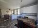 Open concept kitchen featuring white cabinetry, modern appliances, an eat-in table, and wood floors at 650 N Hawes Rd # 3312, Mesa, AZ 85207