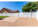 Fenced backyard features a stone patio area, desert landscaping, and privacy walls at 715 S Saranac Ave, Mesa, AZ 85208