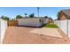 Backyard featuring a gravel area, a stone patio, small turf area and wooden gate at 715 S Saranac Ave, Mesa, AZ 85208