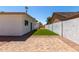 Backyard features a small turf area, gravel area, and a brick patio under a blue sky at 715 S Saranac Ave, Mesa, AZ 85208