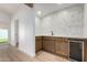 Stylish bar area with hardwood cabinets, a built-in wine fridge, and an undermount sink at 715 S Saranac Ave, Mesa, AZ 85208
