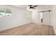 Bright bedroom with wood floors and a barn door leading to the bathroom at 715 S Saranac Ave, Mesa, AZ 85208