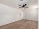 Neutral bedroom with wood floors and a lighted ceiling fan at 715 S Saranac Ave, Mesa, AZ 85208