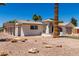 Single-Gathering home showcasing a neutral stucco exterior, arched entry, rock landscaping, and a two-car garage at 715 S Saranac Ave, Mesa, AZ 85208