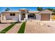Inviting single-Gathering home featuring a well-manicured walkway, desert landscaping, and an arched entry at 715 S Saranac Ave, Mesa, AZ 85208