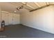 Garage interior featuring neutral walls, concrete floor, and plenty of space for two cars at 715 S Saranac Ave, Mesa, AZ 85208
