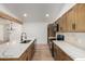 Stylish kitchen with a kitchen island, stainless steel appliances, and hardwood cabinets at 715 S Saranac Ave, Mesa, AZ 85208