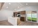 Well-lit kitchen with an island, stainless steel appliances, and a door to the outdoor space at 715 S Saranac Ave, Mesa, AZ 85208