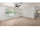 Bright and airy living room showcasing light hardwood floors, a large window, and modern white walls at 715 S Saranac Ave, Mesa, AZ 85208