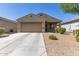 Charming single-story home featuring a neutral color palette, desert landscaping, and an attached two-car garage at 7224 W Puget Ave, Peoria, AZ 85345