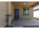 Inviting front porch with a blue door, neutral siding, and a cozy covered entryway perfect for welcoming guests at 7224 W Puget Ave, Peoria, AZ 85345