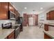 Well-lit kitchen featuring tile flooring, stainless steel appliances, and wooden cabinets with great storage space at 7224 W Puget Ave, Peoria, AZ 85345