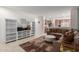 Open-concept living room featuring a plush sectional, neutral color palette, and seamless flow to the kitchen at 7224 W Puget Ave, Peoria, AZ 85345