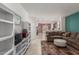 Open living room featuring tile floors, a large sectional, and seamless access to the kitchen and dining areas at 7224 W Puget Ave, Peoria, AZ 85345