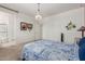 Bedroom features a stylish chandelier, and a view into the bathroom with an open layout for flexible furniture placement at 7224 W Puget Ave, Peoria, AZ 85345