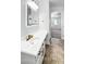 Bathroom vanity with quartz countertops, mirror and gold fixtures at 7243 W Sandra Ter, Peoria, AZ 85382