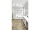 Bathroom features tile floor, garden tub, standing shower, and arched windows at 7243 W Sandra Ter, Peoria, AZ 85382