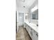 Bathroom with double sinks, white cabinets, and tile flooring, with a separate shower at 7243 W Sandra Ter, Peoria, AZ 85382