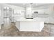Open kitchen with granite countertops, a large island, and white cabinets at 7243 W Sandra Ter, Peoria, AZ 85382