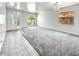 Bright living room with large windows, gray carpet and tile flooring at 7243 W Sandra Ter, Peoria, AZ 85382