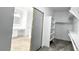 Walk-in closet with built-in shelving and access to the bathroom with double sink at 7243 W Sandra Ter, Peoria, AZ 85382