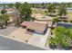 Aerial view of a well-kept single-Gathering home with mature trees, a driveway, and a nearby golf course at 7430 E Ed Rice Ave, Mesa, AZ 85208