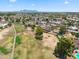 Aerial view of a residential neighborhood featuring a golf course, showcasing a community lifestyle at 7430 E Ed Rice Ave, Mesa, AZ 85208