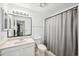 Bathroom with a wide mirror, vanity, toilet, and enclosed shower at 7430 E Ed Rice Ave, Mesa, AZ 85208