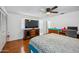 Bedroom with ceiling fan, wood laminate flooring, and a comfortable bed at 7430 E Ed Rice Ave, Mesa, AZ 85208
