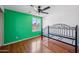 Bedroom with laminate flooring, ceiling fan, and natural light from the window at 7430 E Ed Rice Ave, Mesa, AZ 85208