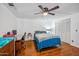 Bedroom with ceiling fan, wood laminate flooring, and a comfortable bed at 7430 E Ed Rice Ave, Mesa, AZ 85208