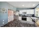 Bright kitchen with stainless steel appliances, granite countertops, and a cozy dining area at 7430 E Ed Rice Ave, Mesa, AZ 85208