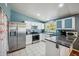 Bright kitchen featuring white cabinets, granite countertops, and stainless steel appliances at 7430 E Ed Rice Ave, Mesa, AZ 85208