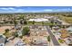 Aerial view showcasing a neighborhood with a school and sports fields in the distance at 7431 W Mclellan Rd, Glendale, AZ 85303