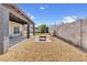 Gravel-covered backyard featuring a covered patio with ceiling lights and a block wall perimeter at 7431 W Mclellan Rd, Glendale, AZ 85303