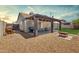 Inviting backyard with a covered patio, outdoor grill, and a gravel-covered landscape at 7431 W Mclellan Rd, Glendale, AZ 85303
