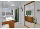 Well-lit bathroom featuring a vanity with storage, a large mirror, and a window for natural light at 7431 W Mclellan Rd, Glendale, AZ 85303