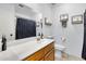 Bright bathroom with wooden cabinets, a large mirror, a sink and tiled floors at 7431 W Mclellan Rd, Glendale, AZ 85303