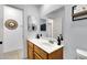 Bathroom with wooden cabinets, a large mirror, a sink and tiled floors at 7431 W Mclellan Rd, Glendale, AZ 85303