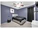 Cozy bedroom featuring neutral carpet, a ceiling fan, and a large window at 7431 W Mclellan Rd, Glendale, AZ 85303